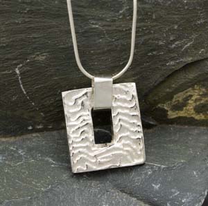 Silver cuttlefish cast oblong pendant with oblong hole in centre
