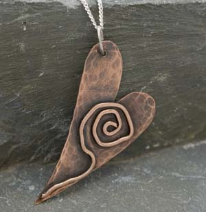 Heart shaped hammered  copper pendant with copper detail